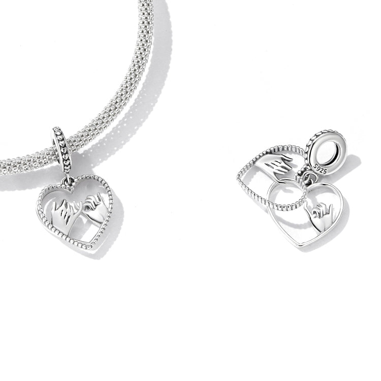 Sterling silver bracelet with dangling heart charms featuring hand-swearing hands