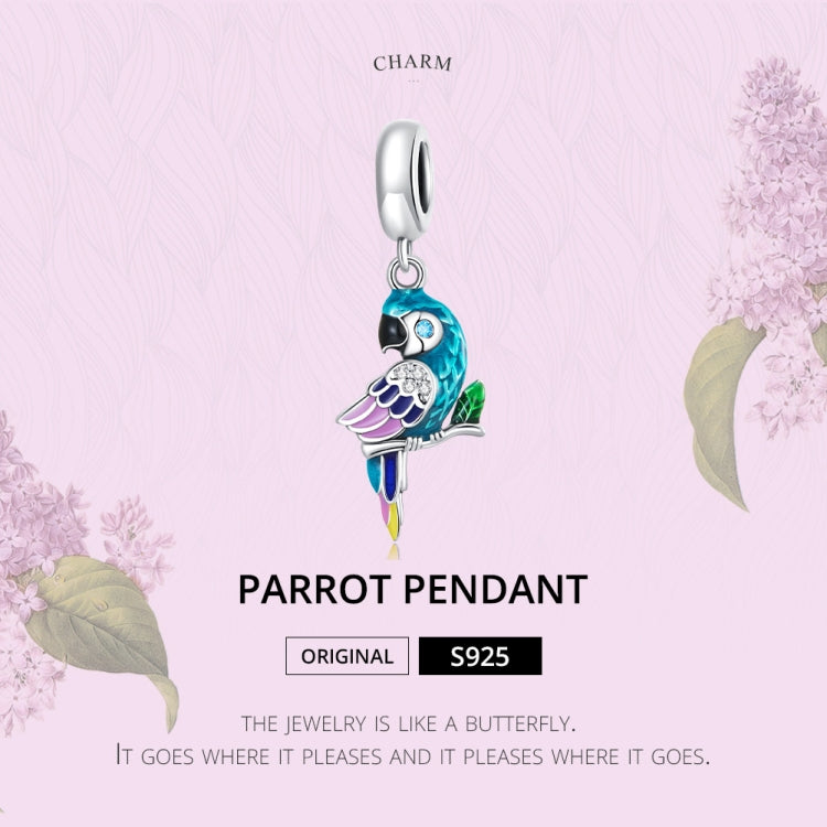 Parrot pendant charm with turquoise enamel wings, purple accents, and silver hanging loop