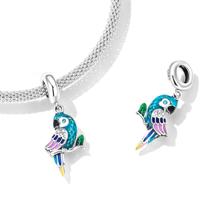 Silver chain bracelet with two parrot pendant charms, turquoise enamel and purple accents