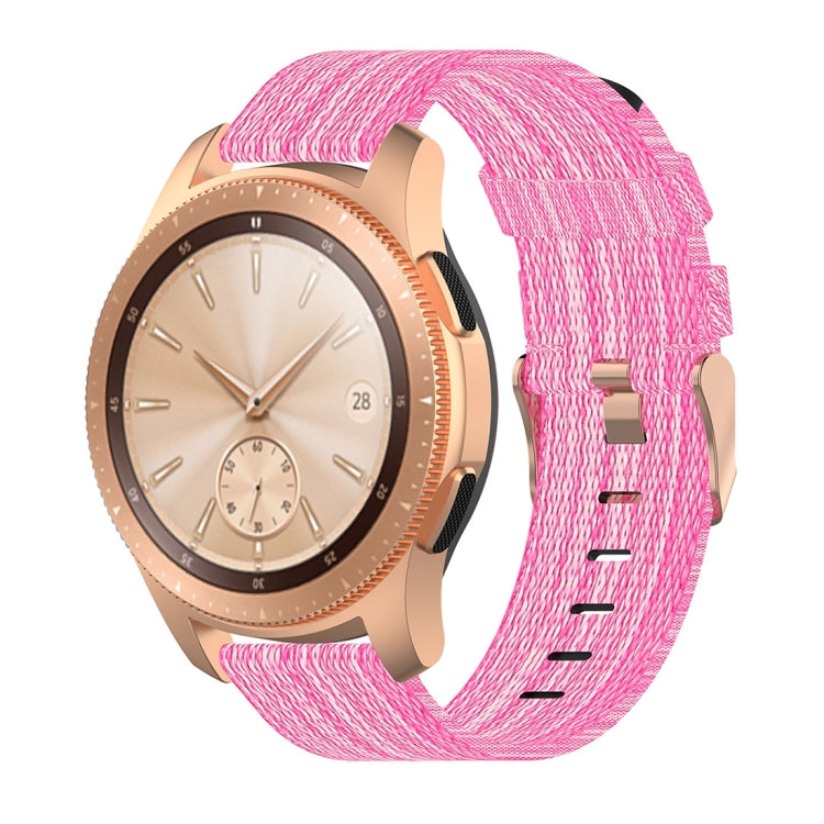 Pink nylon canvas watch strap with metal buckle, worn on a round smartwatch
