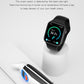 Black smartwatch on stand with green circular temperature-style display