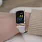 White leather slim watch band with gold-tone buckle on wrist for Fitbit Charge 5