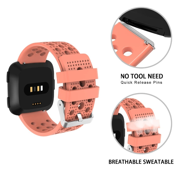 Breathable perforated TPU watch strap with quick-release for Fitbit Versa, coral orange.
