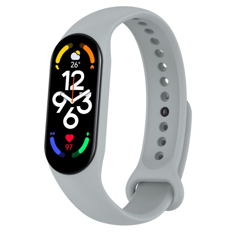 Light gray silicone smartwatch band with oval display and side pin hole detail