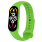 Bright green silicone smartwatch band with perforation holes and pin clasp, tracker display visible.