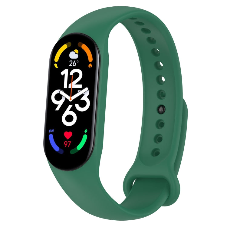 Teal green silicone smartwatch band with perforation holes and pin clasp, tracker display visible.