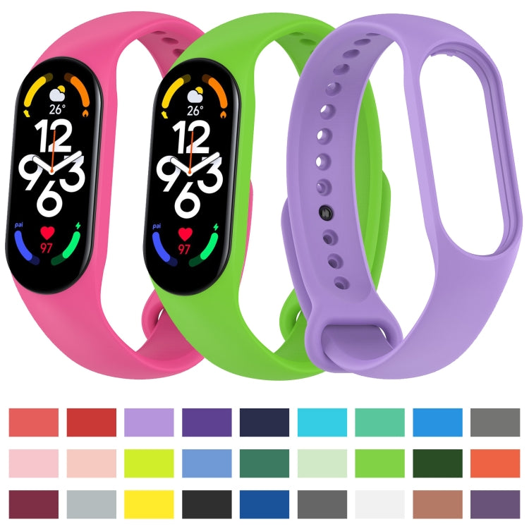 Set of silicone watch bands in pink, green, and purple with perforated strap
