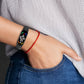 Dark gray silicone watch band with perforated strap on wrist