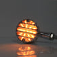Lit amber retro LED turn signal with black housing and ribbed lens, single lamp.