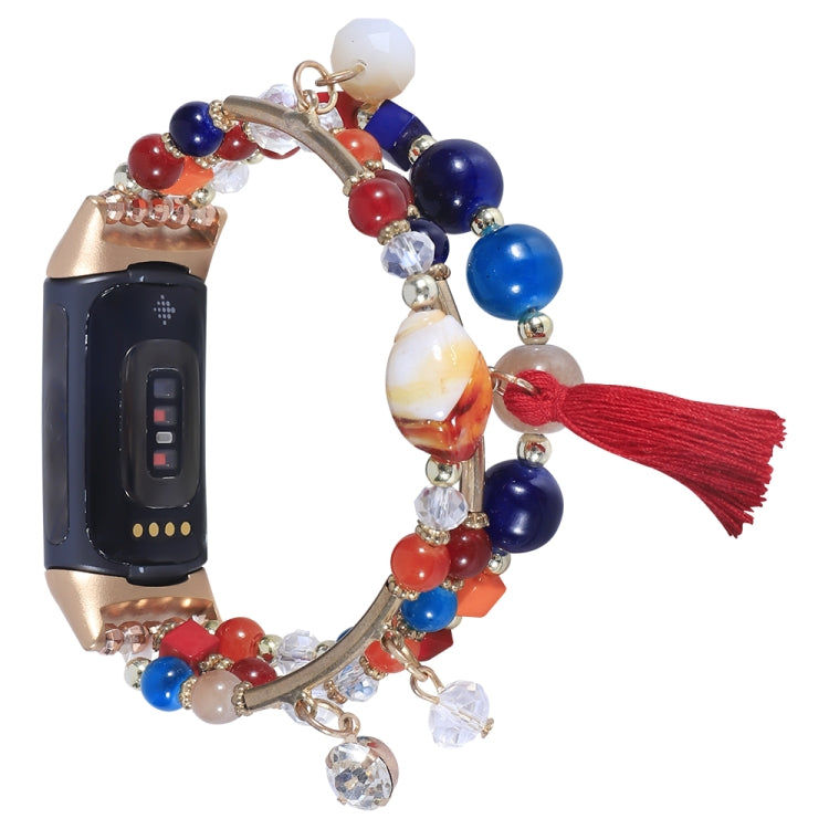 Bead chain watch band with red, blue, and crystal charms, gold links, tassel accents