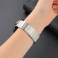 Magnetic steel watch band in silver on wrist, close-up of metal link fit