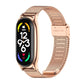 Rose gold stainless steel mesh watch strap with buckle, curved link design.