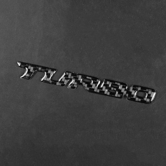Black carbon-fiber style decal, raised letter emblem with glossy metallic blocks