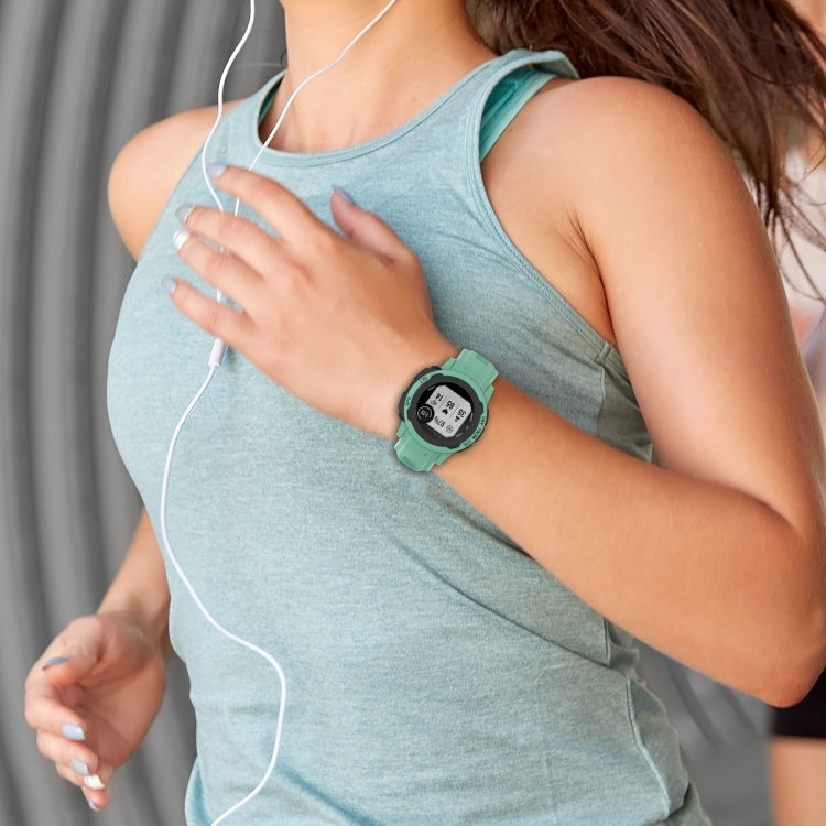 Silicone sports watch band in light teal worn on wrist with smartwatch