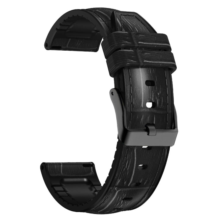 Black textured silicone watch band with metal buckle and strap holes, angled view