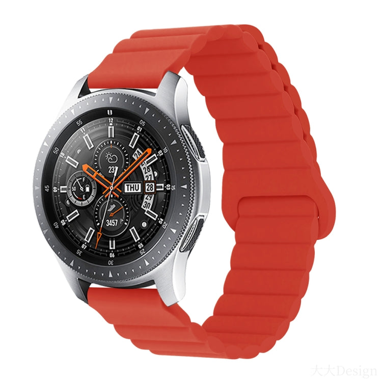 Smart watch with red silicone band and metal clasp, round black dial with orange details