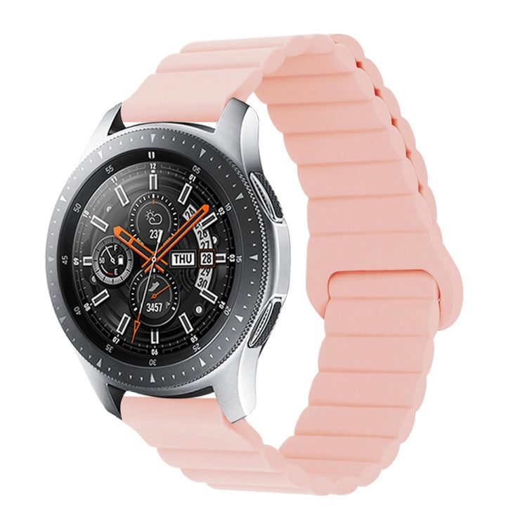 Pink silicone watch band with reverse buckle and magnetic clasp, segmented links.