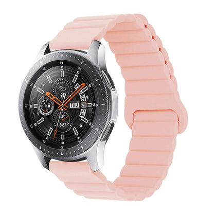 Pink silicone watch band with reverse buckle and magnetic clasp, segmented links.