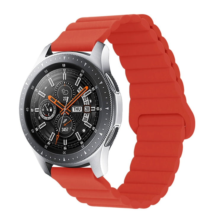 Red silicone watch band with reverse buckle and magnetic clasp, segmented links.