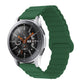 Green silicone watch band with reverse buckle and magnetic clasp, segmented links.