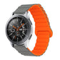 Grey and orange two-tone silicone watch band with reverse buckle and magnetic clasp.