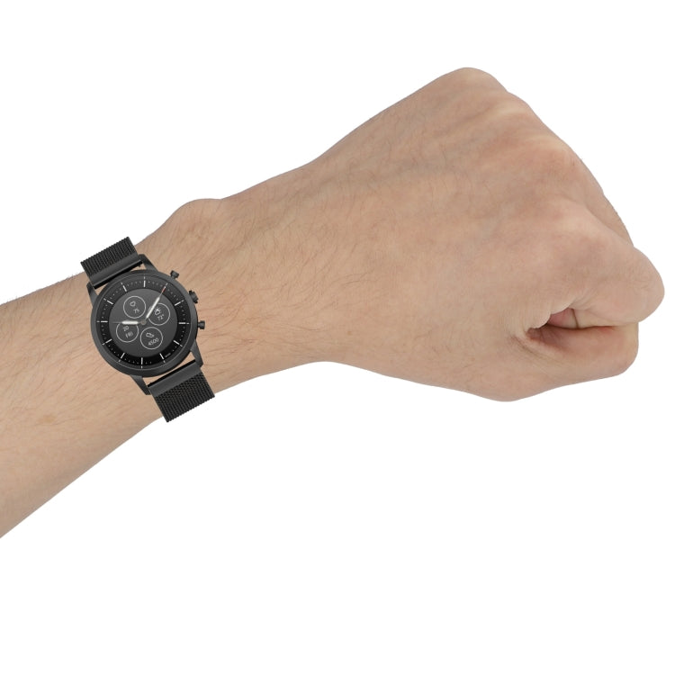 Black Milanese watch band on a wrist, integrated buckle and mesh links visible.