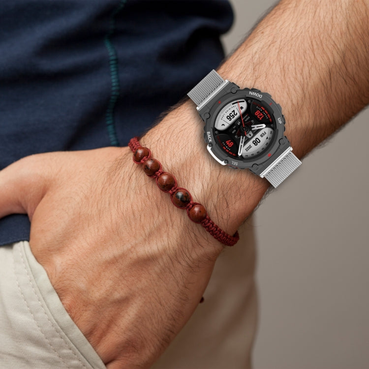 Silver mesh watch band with snap-fit clasp worn on wrist