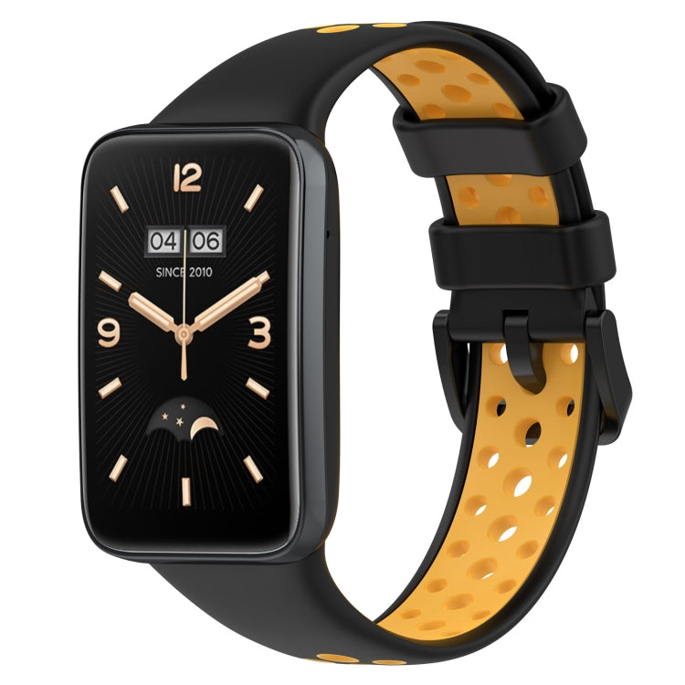 Two-color breathable silicone watch band with perforations, black and yellow-orange, buckle clasp.