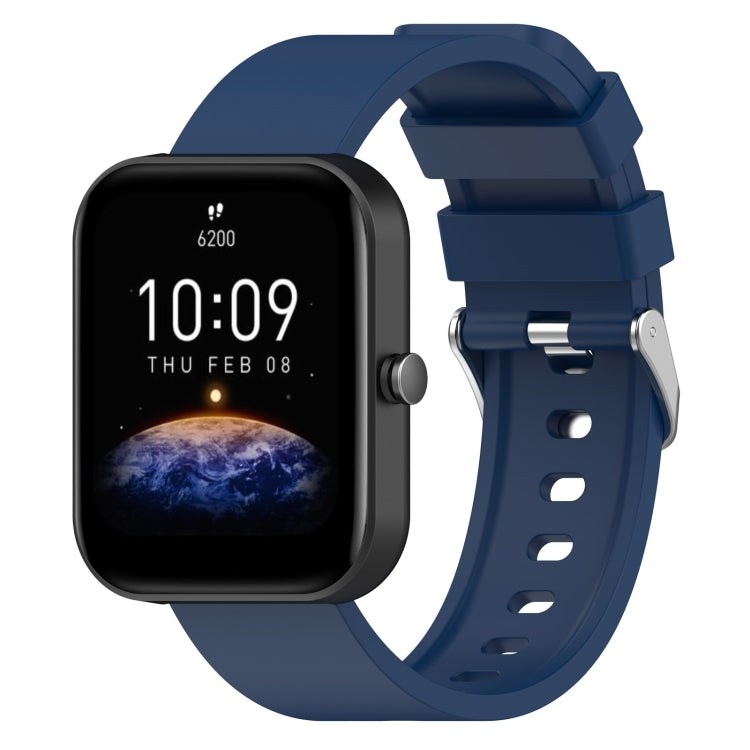 Royal blue silicone watch band with metal buckle and adjustment holes, shown with matching smartwatch.