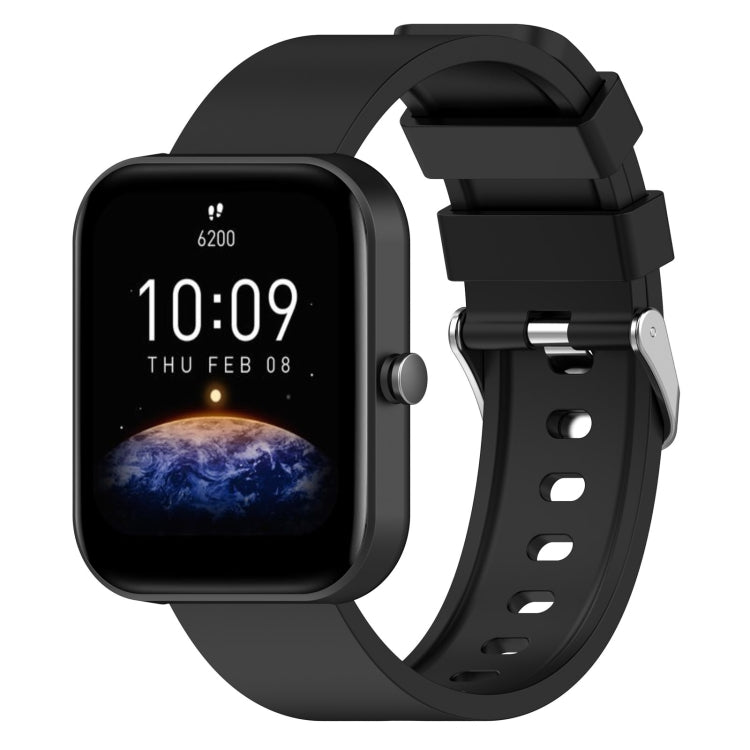 Black silicone watch band with metal buckle and adjustment holes, shown with matching smartwatch.