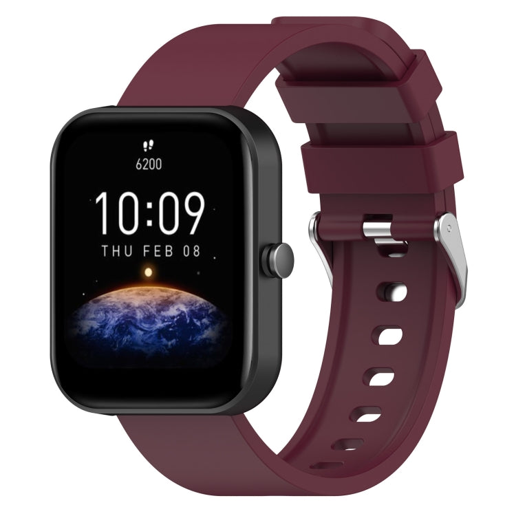 Burgundy silicone watch band with metal buckle and perforated strap holes