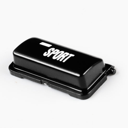 Black sport mode button with SPORT logo on top