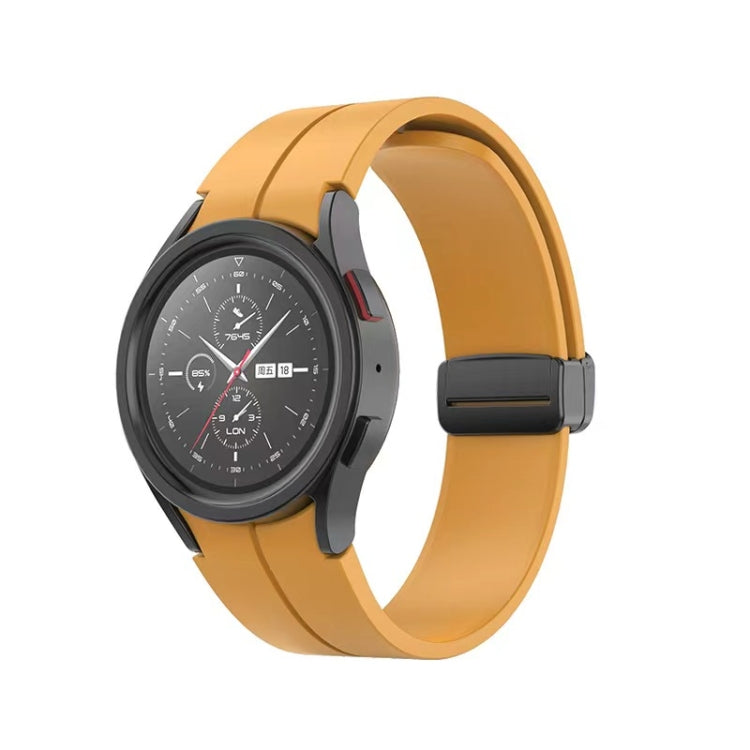 Yellow folding silicone watch band with dark buckle and curved strap profile.