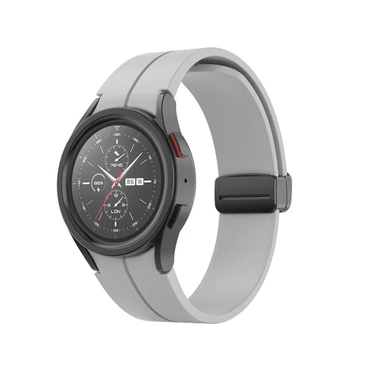 Grey folding silicone watch band with dark buckle and smooth curved silicone strap.