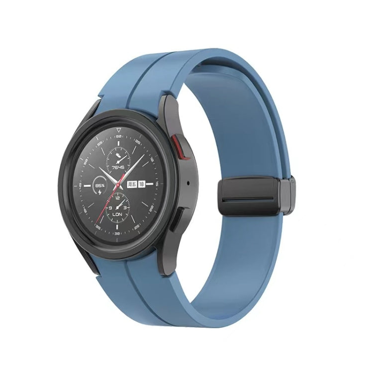 Blue folding silicone watch band with dark buckle and rounded strap edges.