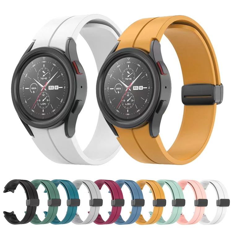 Set of white and yellow folding silicone watch bands with dark buckles.