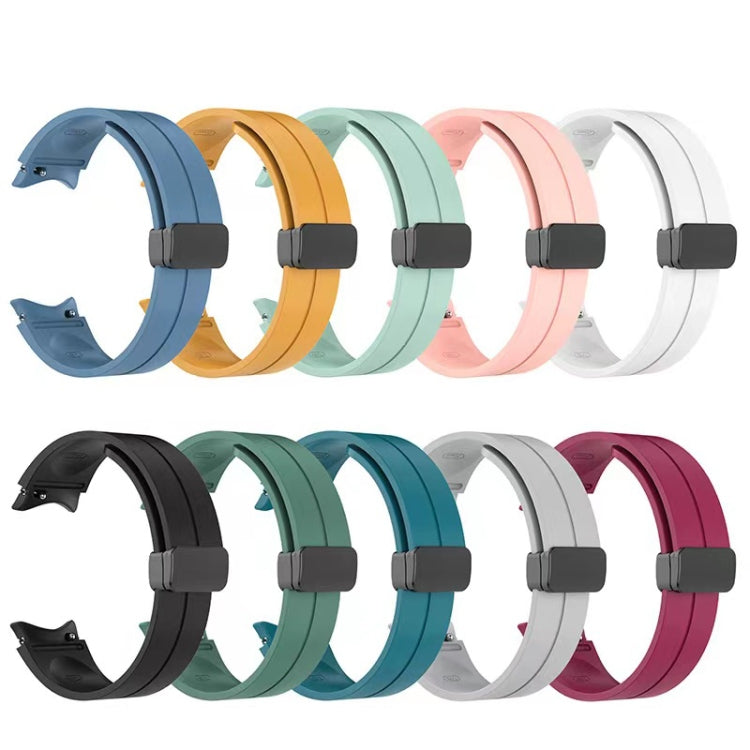 Assorted folding silicone watch bands in multiple colors, each with dark buckle.