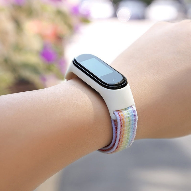 Rainbow woven loop watch band on fitness tracker, multicolor strap