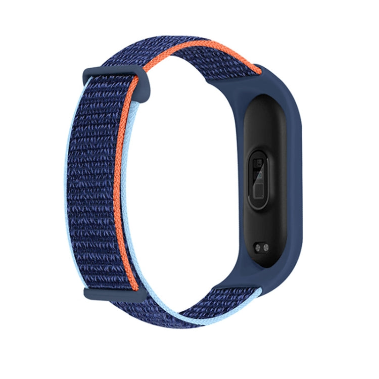 Navy loop watch band with orange inner edge stripe on dark tracker housing