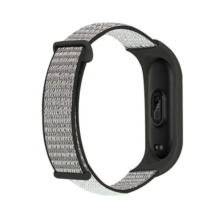 Nylon two-section loop watch band with light gray woven strap and black watch bezel
