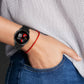 Black cross-textured silicone smartwatch band on wrist with metal clasp