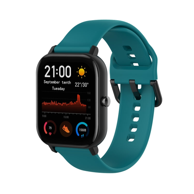 Teal soft silicone smartwatch band with adjustable holes and clasp.
