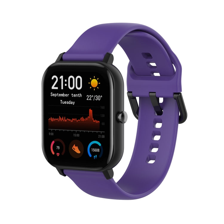 Purple soft silicone smartwatch band with adjustable holes and secure buckle.