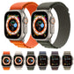 Pair of nylon loop Apple Watch bands in orange and dark gray fabric straps.