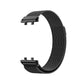 Black Milanese metal watch band with clasp detail, curved mesh weave design.