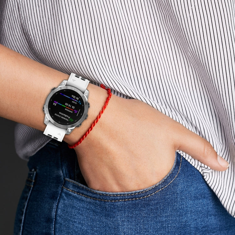 Silicone watch band on wrist: white perforated strap with red accent loop
