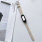 White genuine leather watch band with silver buckle and black smartwatch face