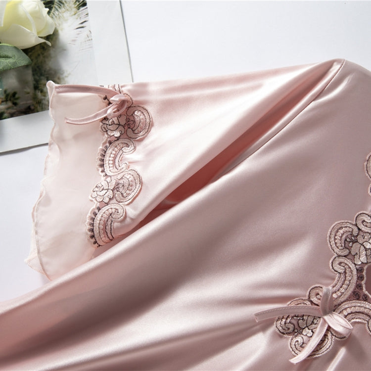 Close-up of blush pink satin nightdress with embroidered V-neck trim and bow detail