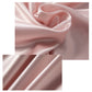 Blush pink satin nightdress fabric close-up with soft sheen