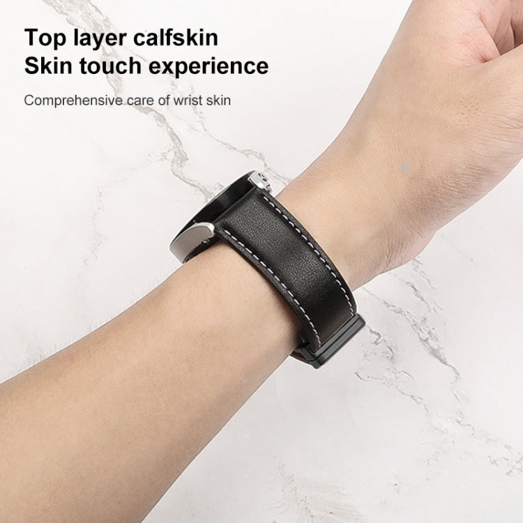 Black genuine leather watch band with stitched edge and metal clasp on wrist